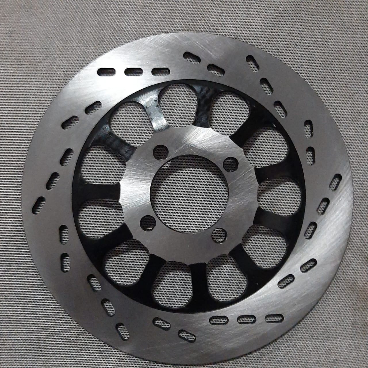 DISCO DE FRENO DEL GN125H/HJ125 (4 AGUJEROS)